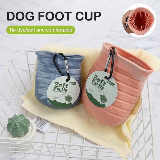 Two dog foot cups, one blue and one pink, with carabiners on a white surface.
